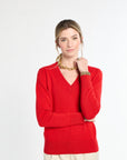 Woman wearing a red sweater on a white background