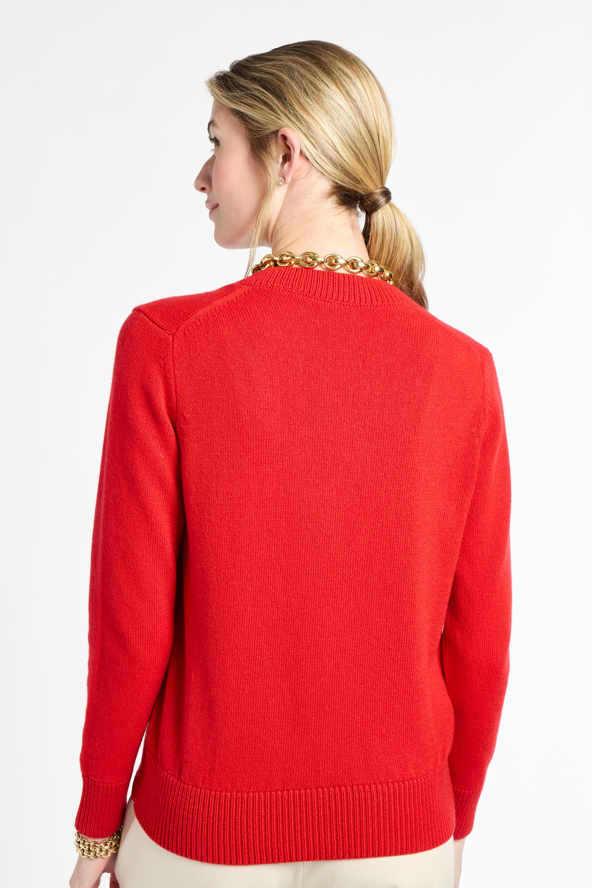 Woman wearing a red sweater on a white background