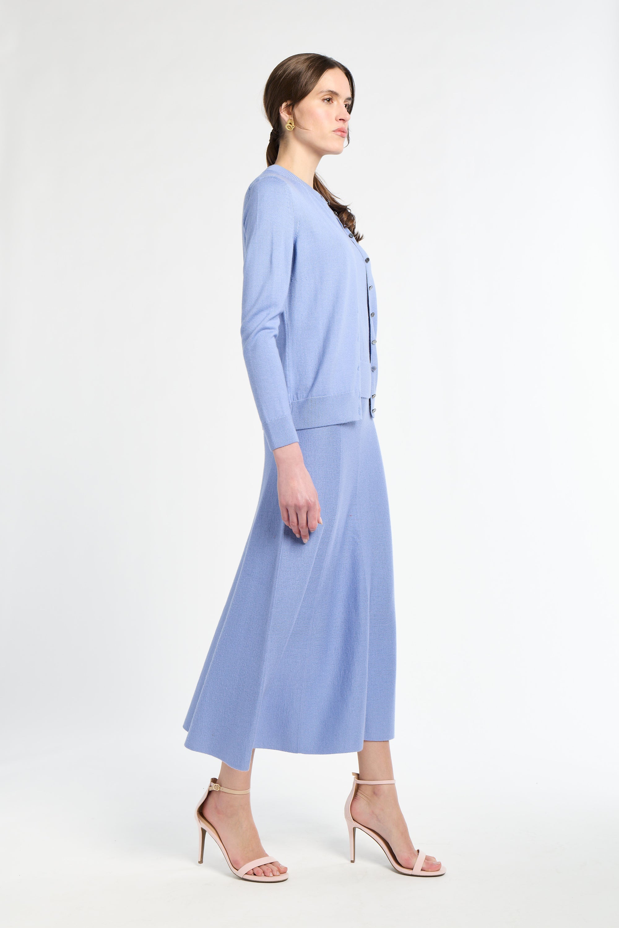 Woman wearing a light blue outfit on a white background