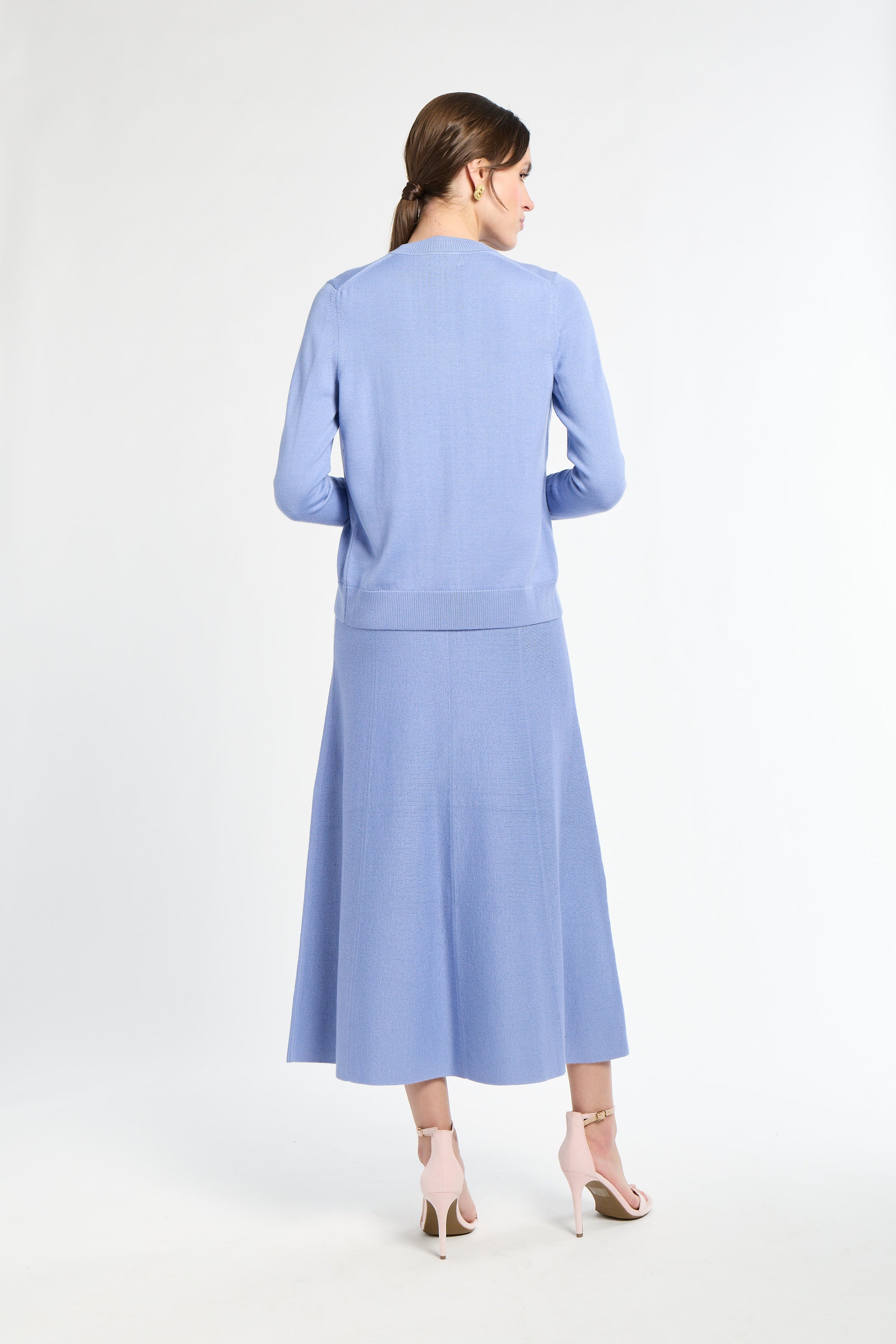 Woman wearing a light blue outfit on a white background