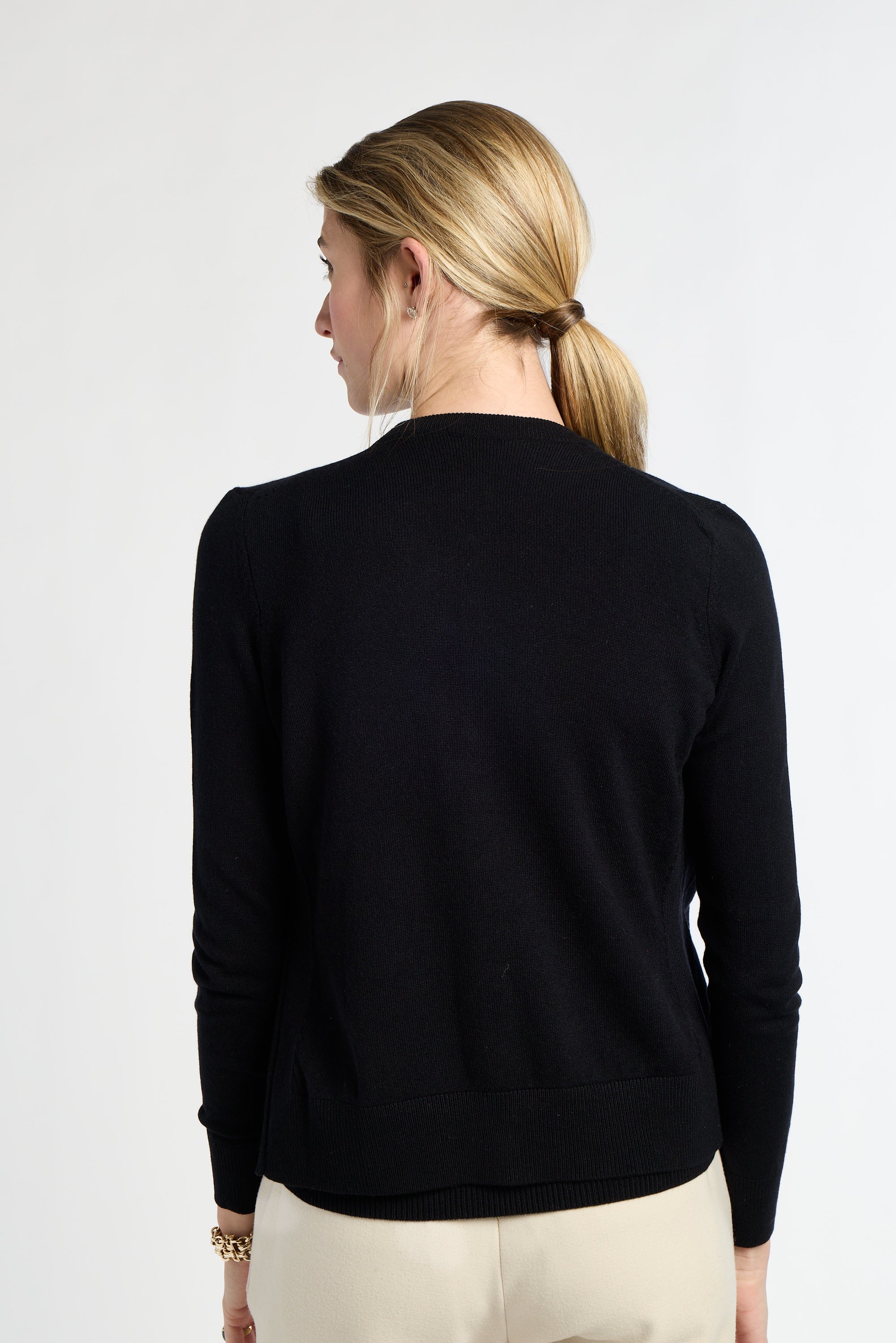 Woman wearing a black sweater on a white background