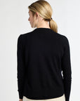 Woman wearing a black sweater on a white background