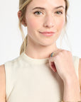 Woman wearing a gold bracelet on a white background