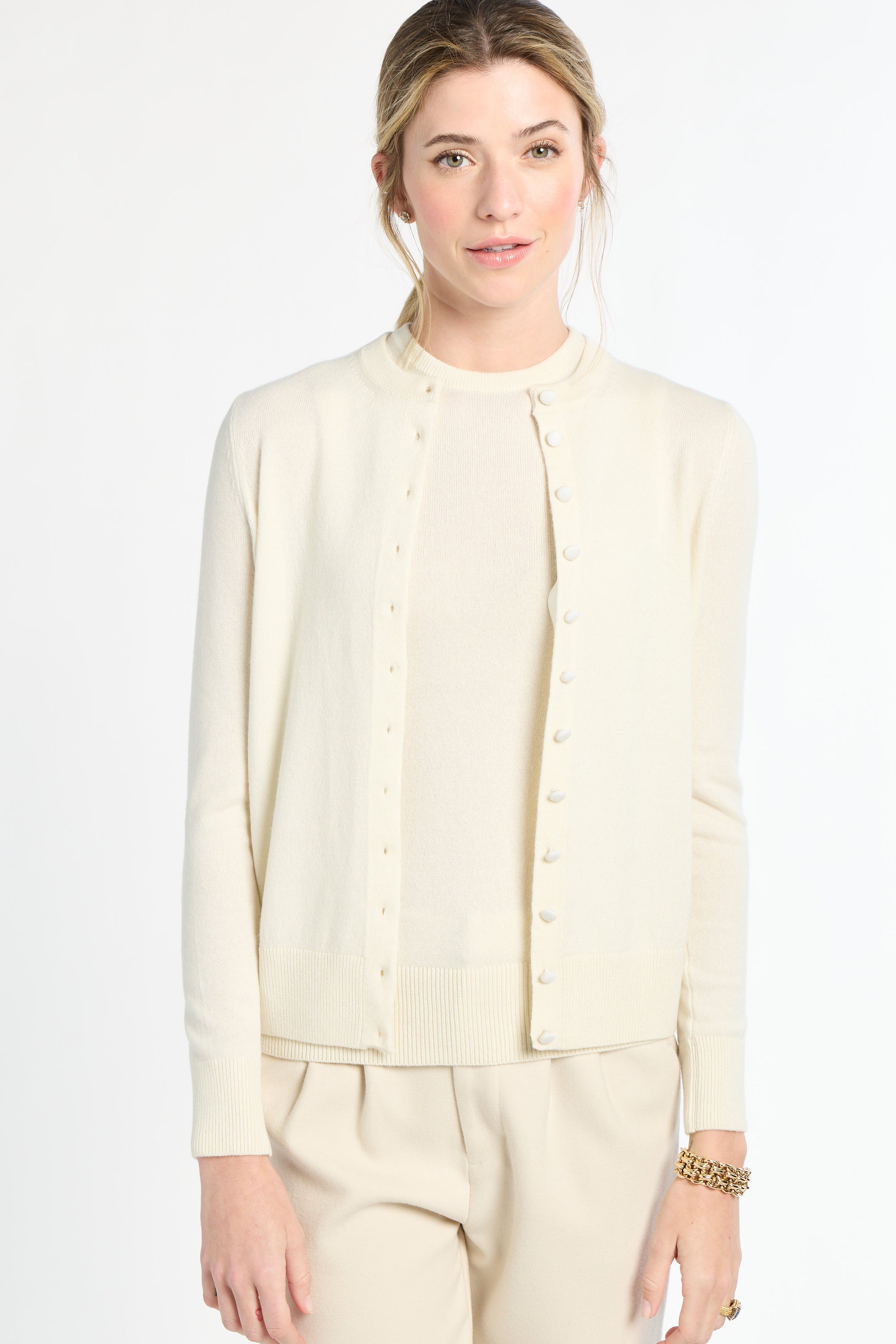 Woman wearing a cream-colored outfit on a white background