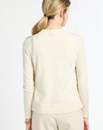 Woman wearing a cream-colored suit on a white background