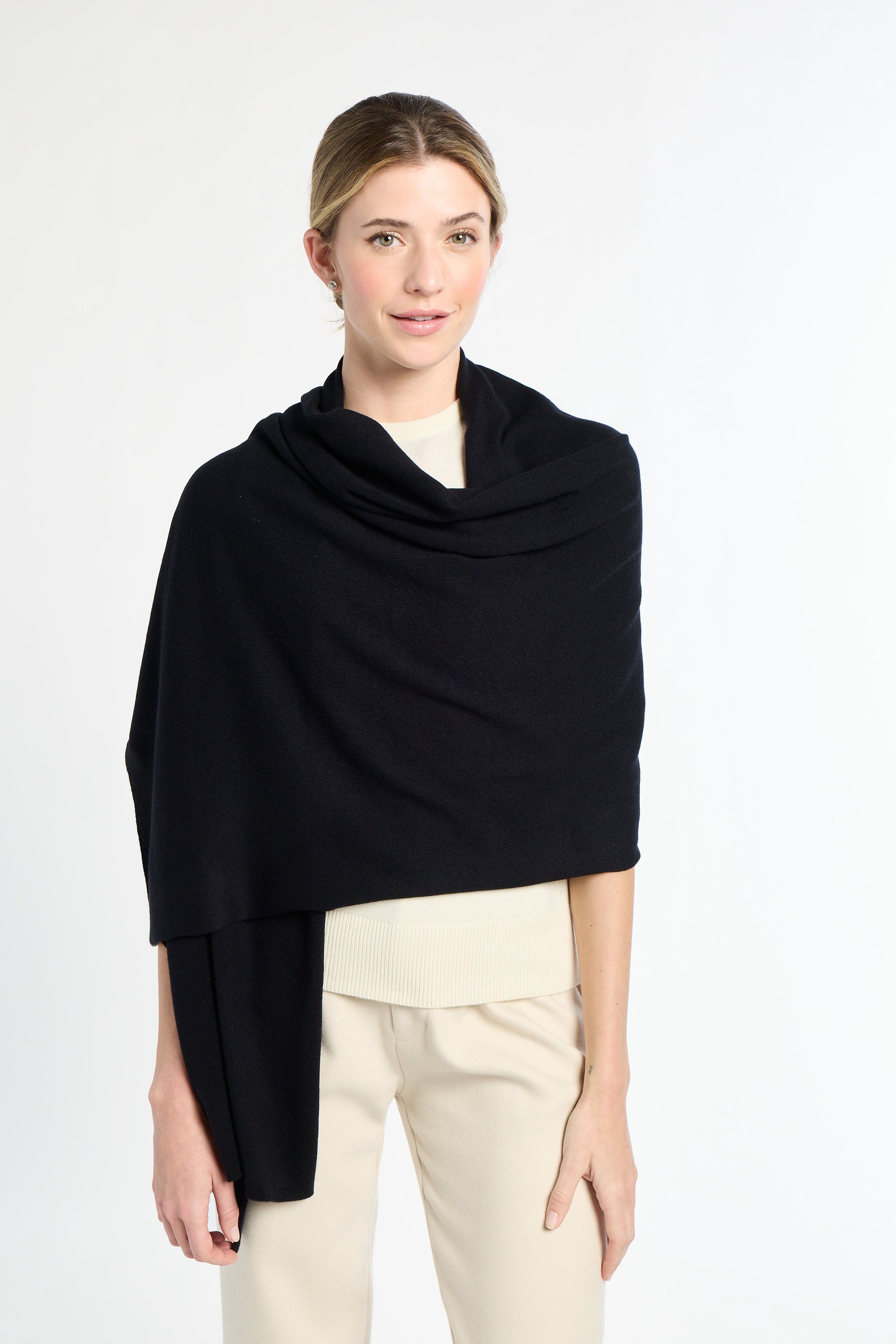 Woman wearing a black shawl over a white background