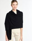 Woman wearing a black shawl over a white background