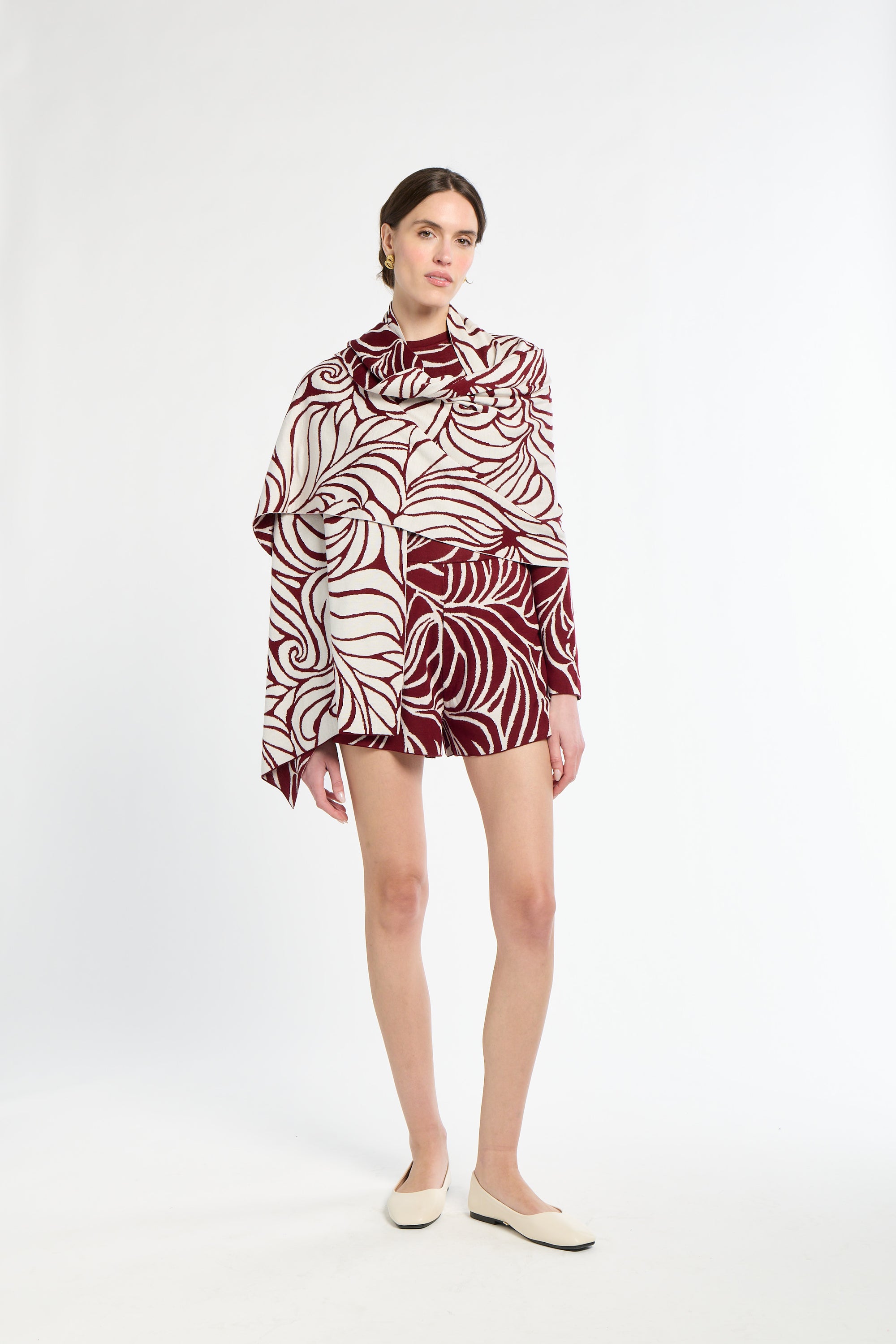 Woman wearing a patterned dress on a white background