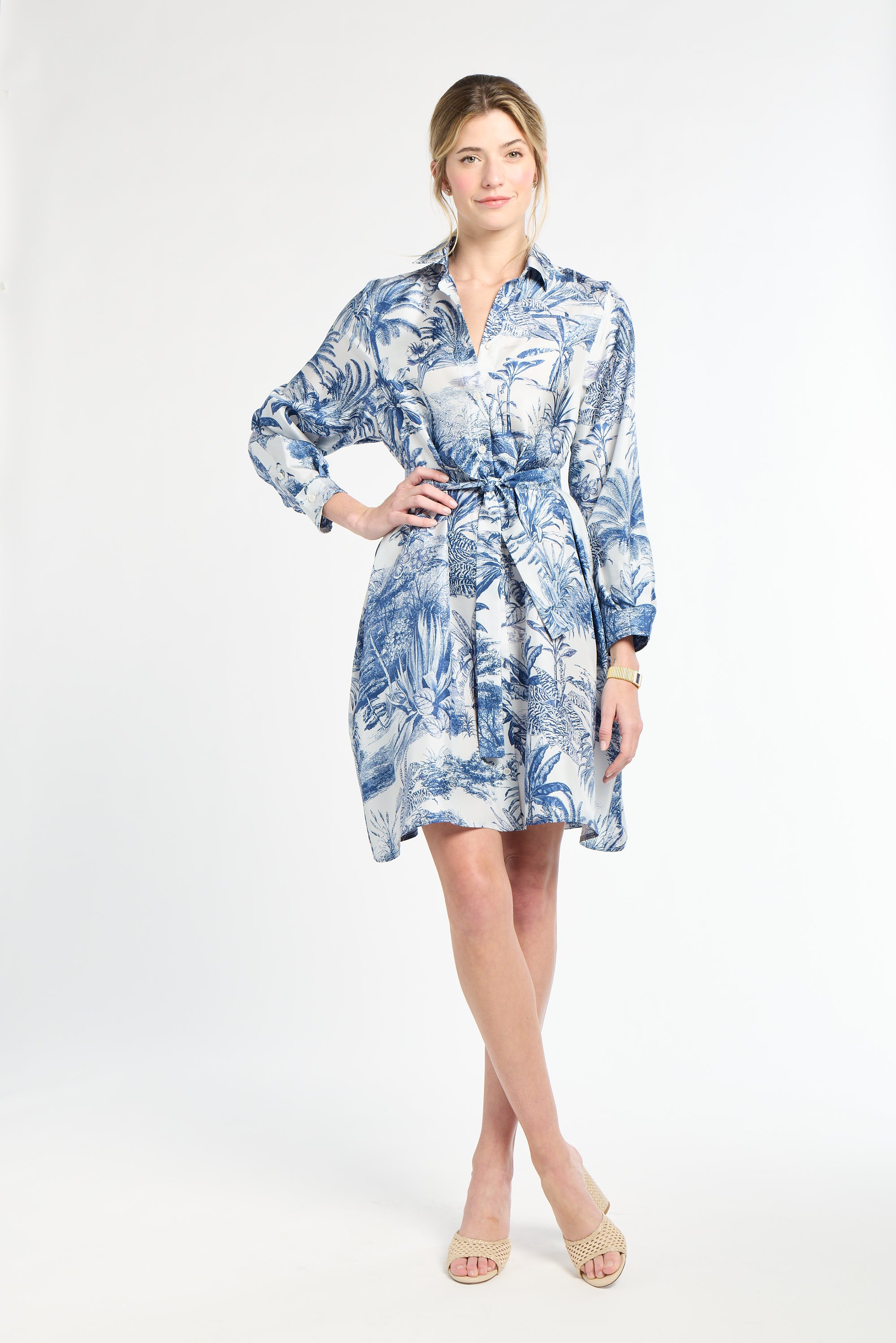 Woman wearing a blue and white floral dress on a white background