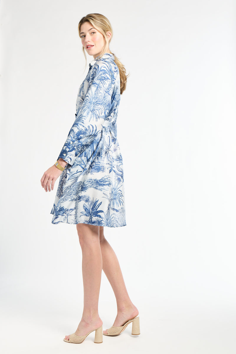 Woman modeling a blue floral dress in heels on a white background