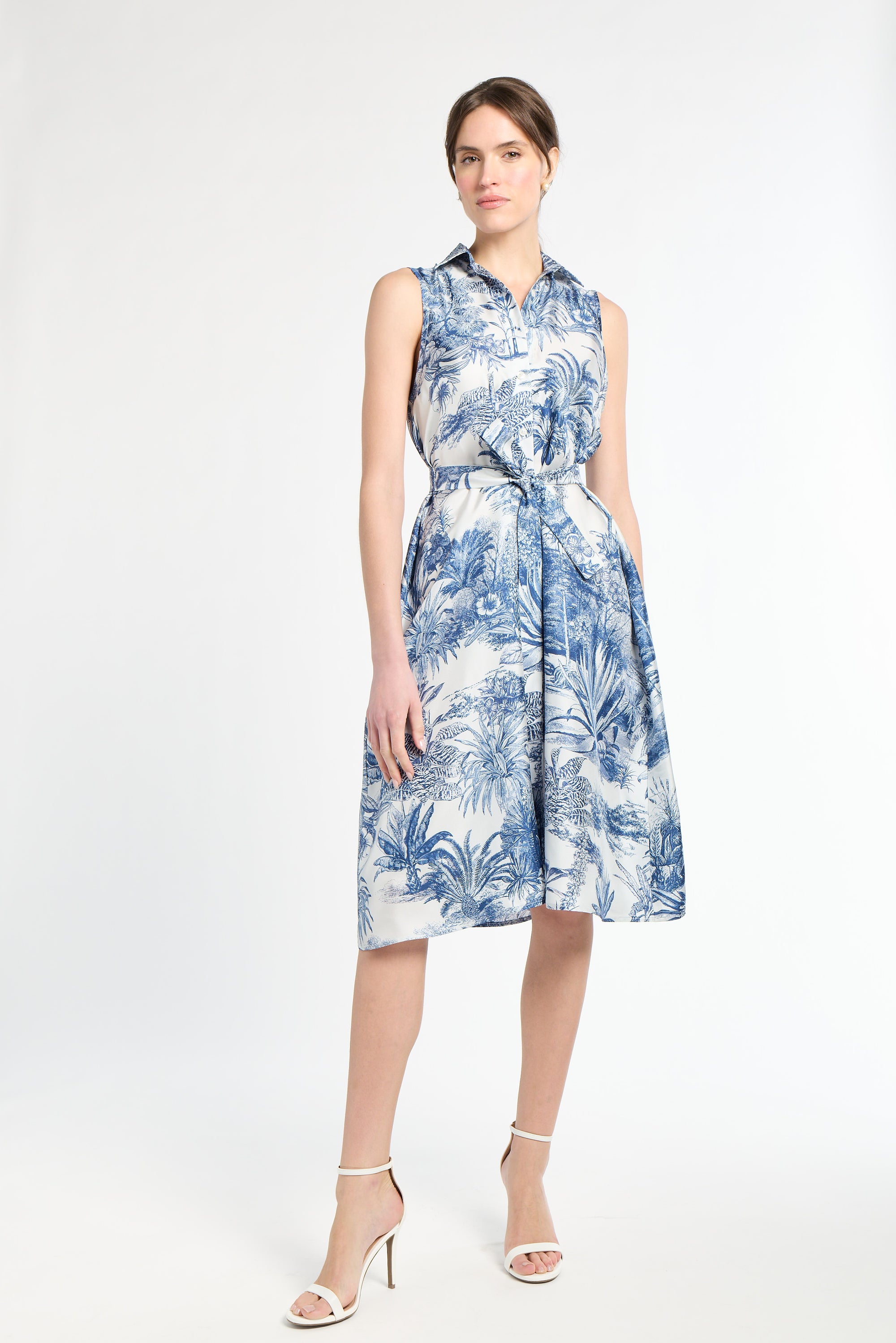 woman modeling blue patterned dress on white background