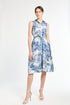 woman modeling blue patterned dress on white background
