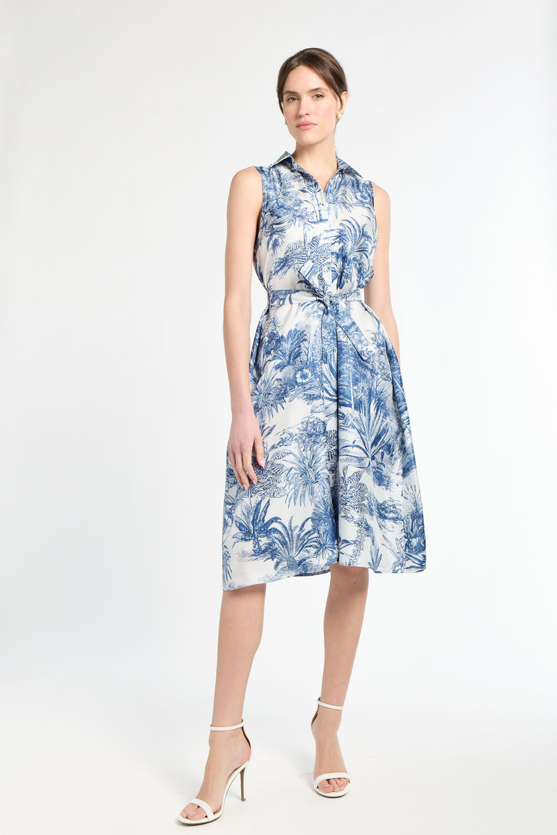 woman modeling blue patterned dress on white background