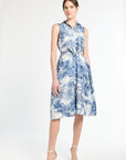 woman modeling blue patterned dress on white background