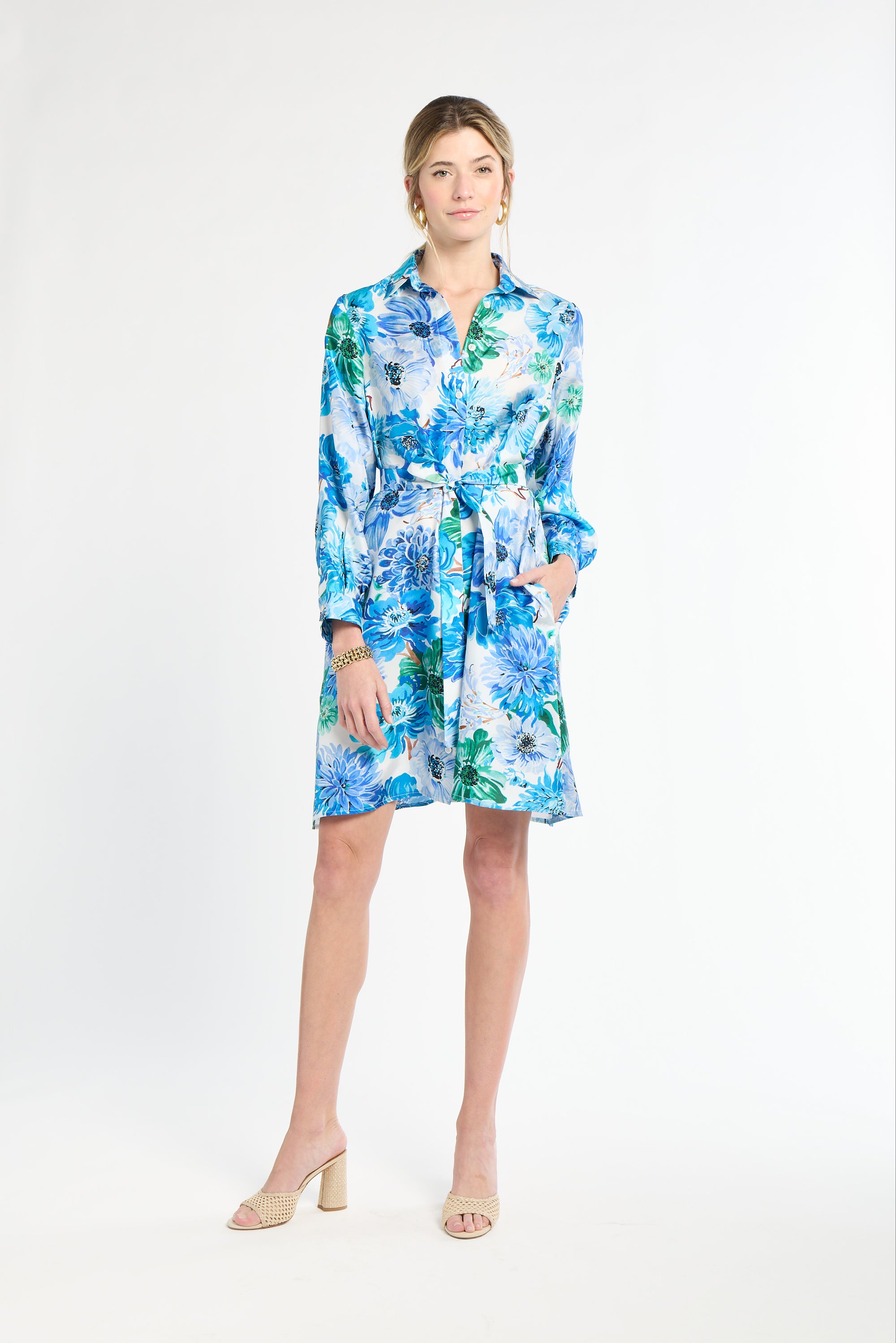 Woman wearing a silk floral dress on a white background