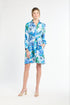 Woman wearing a silk floral dress on a white background