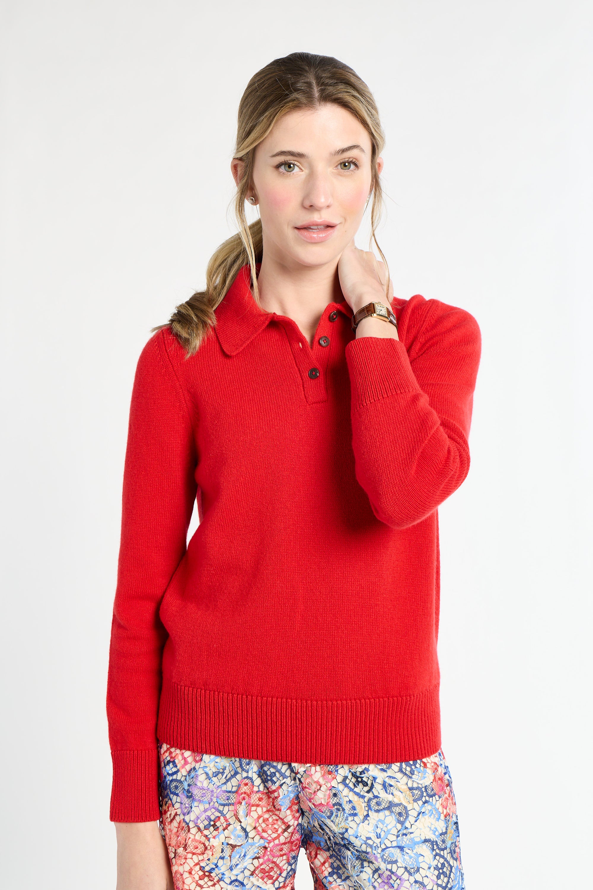 Woman wearing a red sweater with a white background