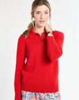 Woman wearing a red sweater with a white background