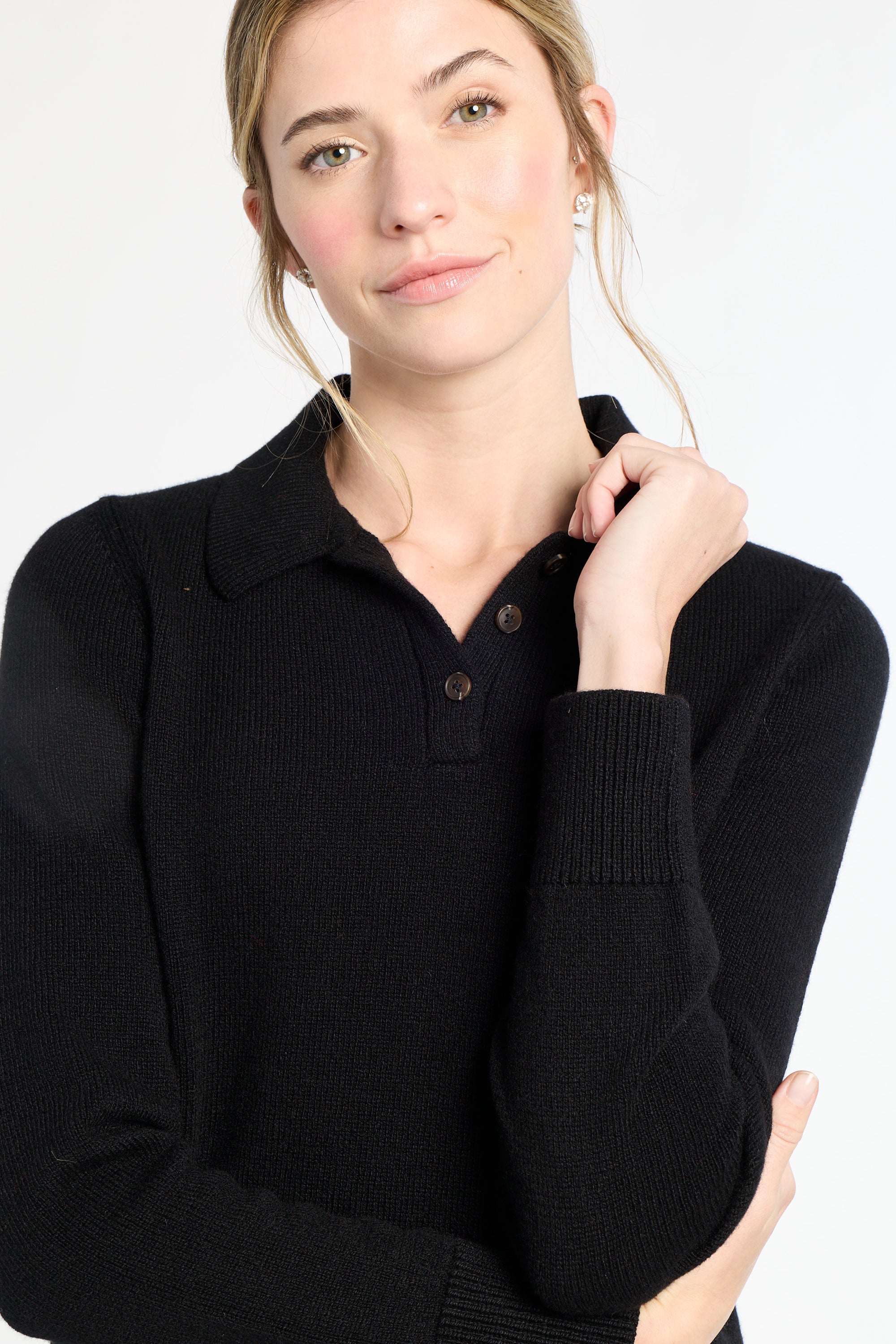 Woman wearing a black sweater with a white background