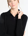 Woman wearing a black sweater with a white background