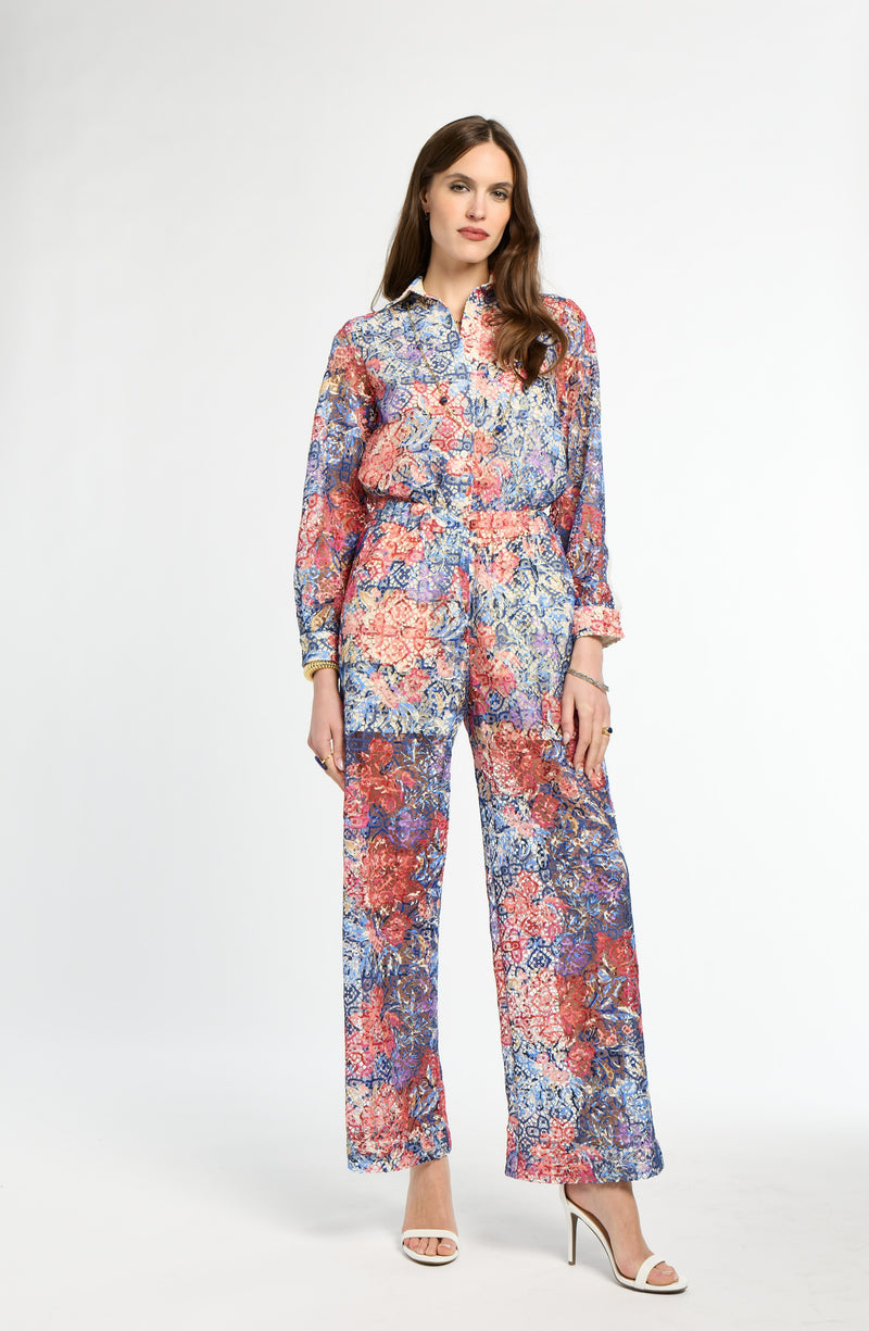 Woman wearing a floral jumpsuit on a white background