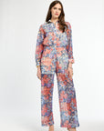 Woman wearing a floral jumpsuit on a white background