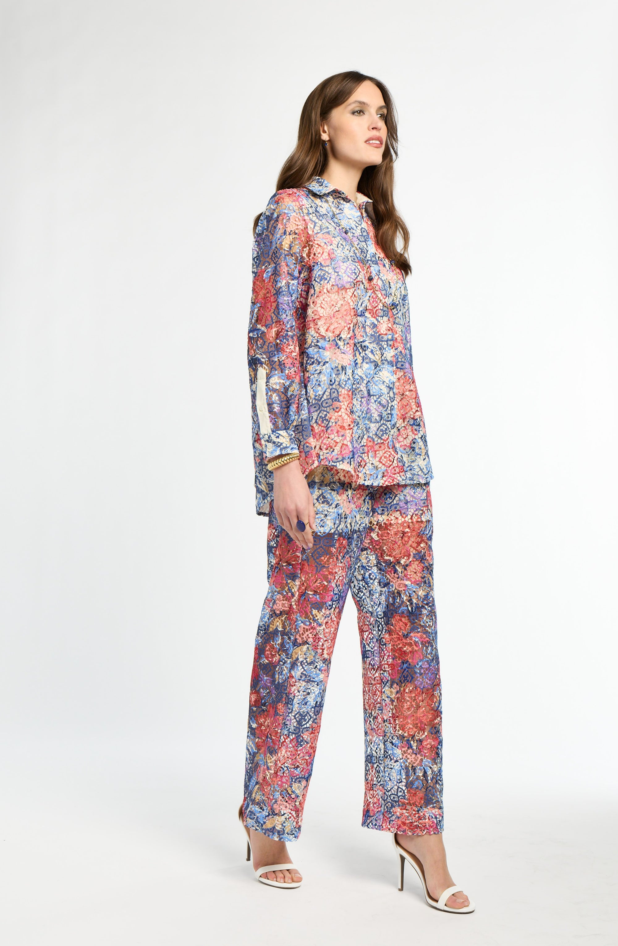 Woman wearing a colorful floral outfit on a white background