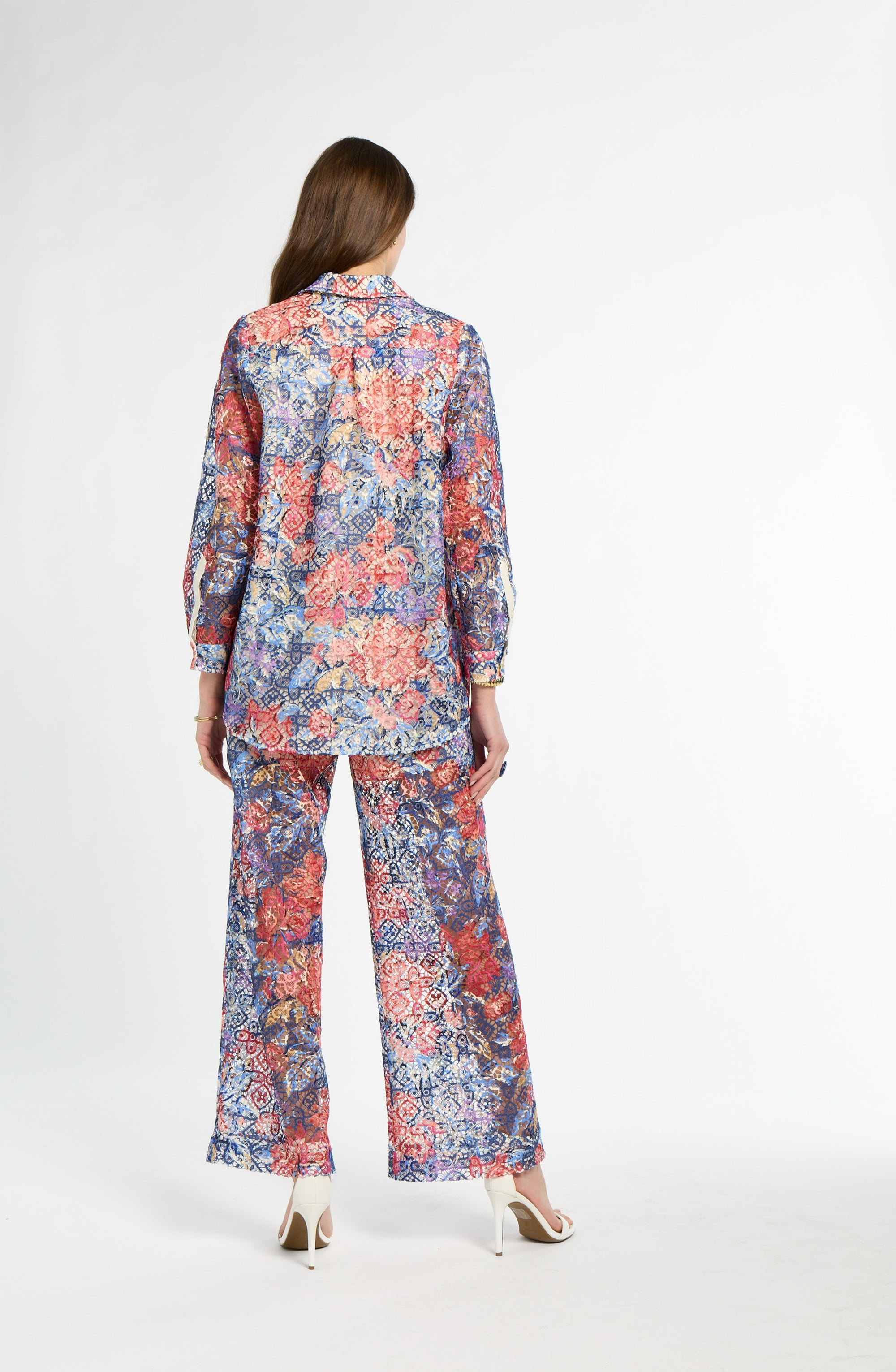 Woman wearing a floral pajama set on a white background