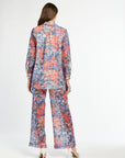 Woman wearing a floral pajama set on a white background