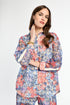 Woman wearing a colorful floral outfit on a white background