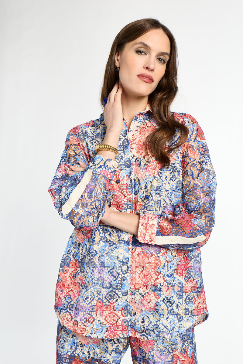 Woman wearing a colorful floral outfit on a white background