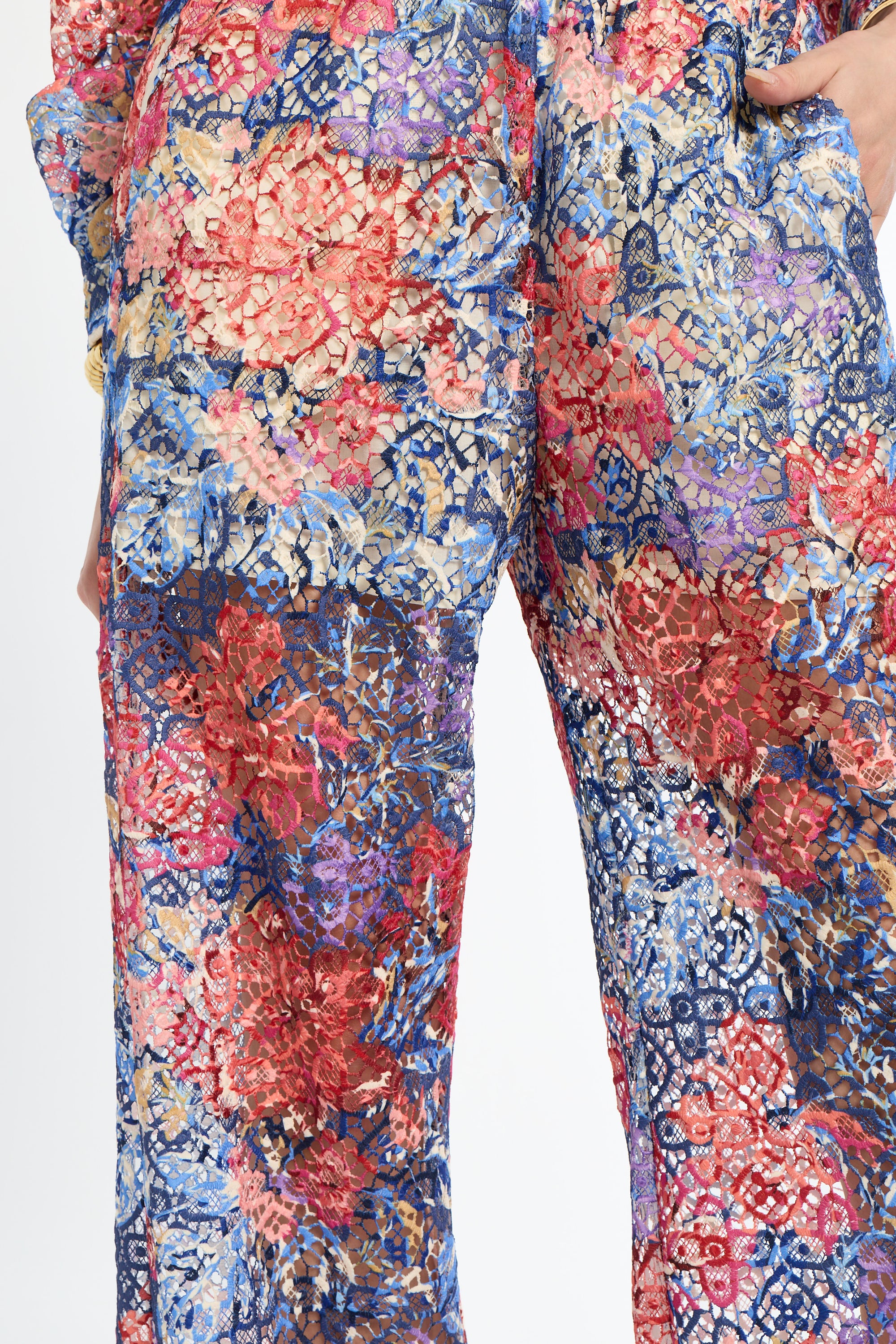 Floral patterned pants with a mix of red, blue, and pink colors on a white background.