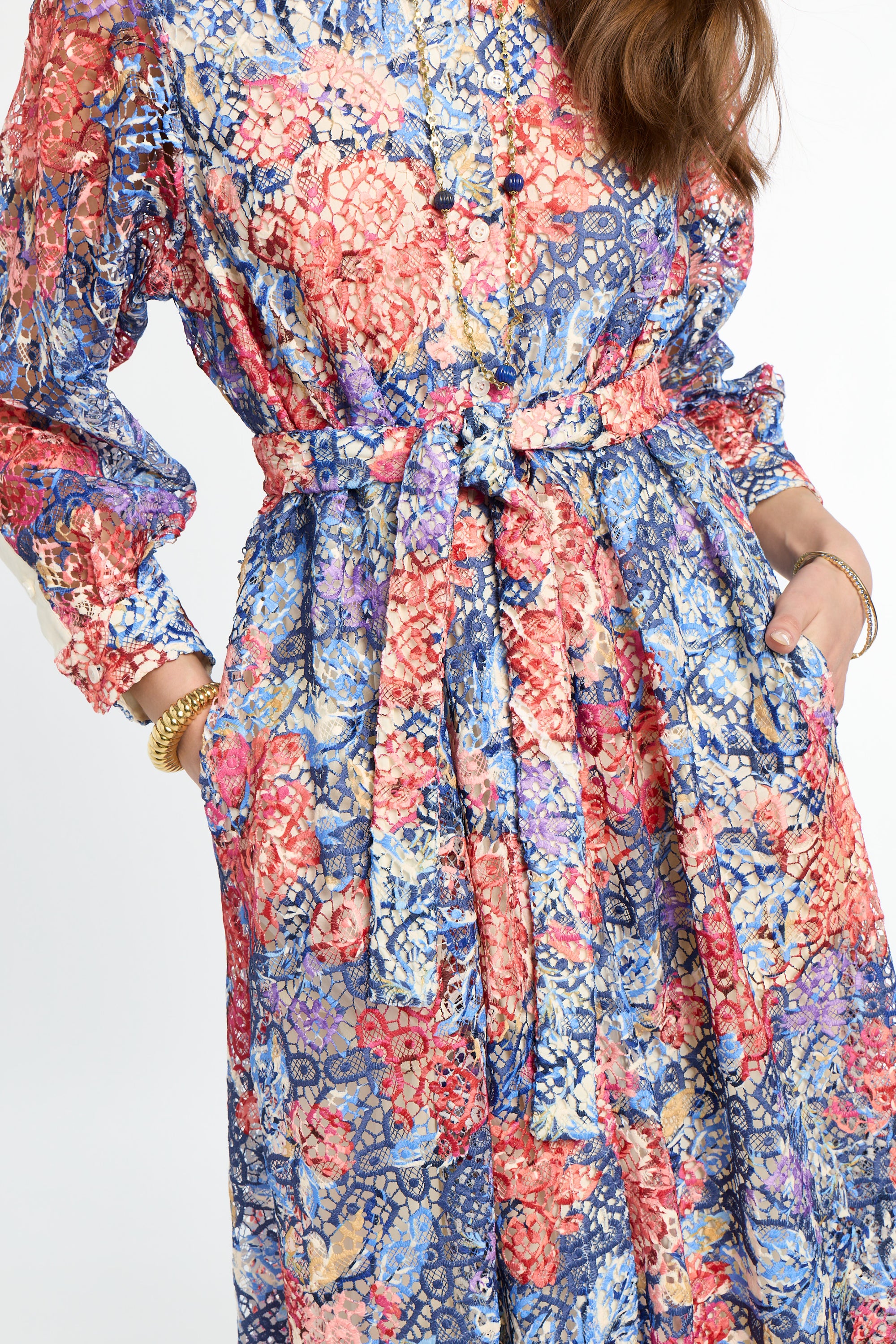 Multicolored floral dress with long sleeves on a white background