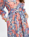 Multicolored floral dress with long sleeves on a white background