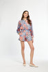 Woman wearing a floral dress on a white background