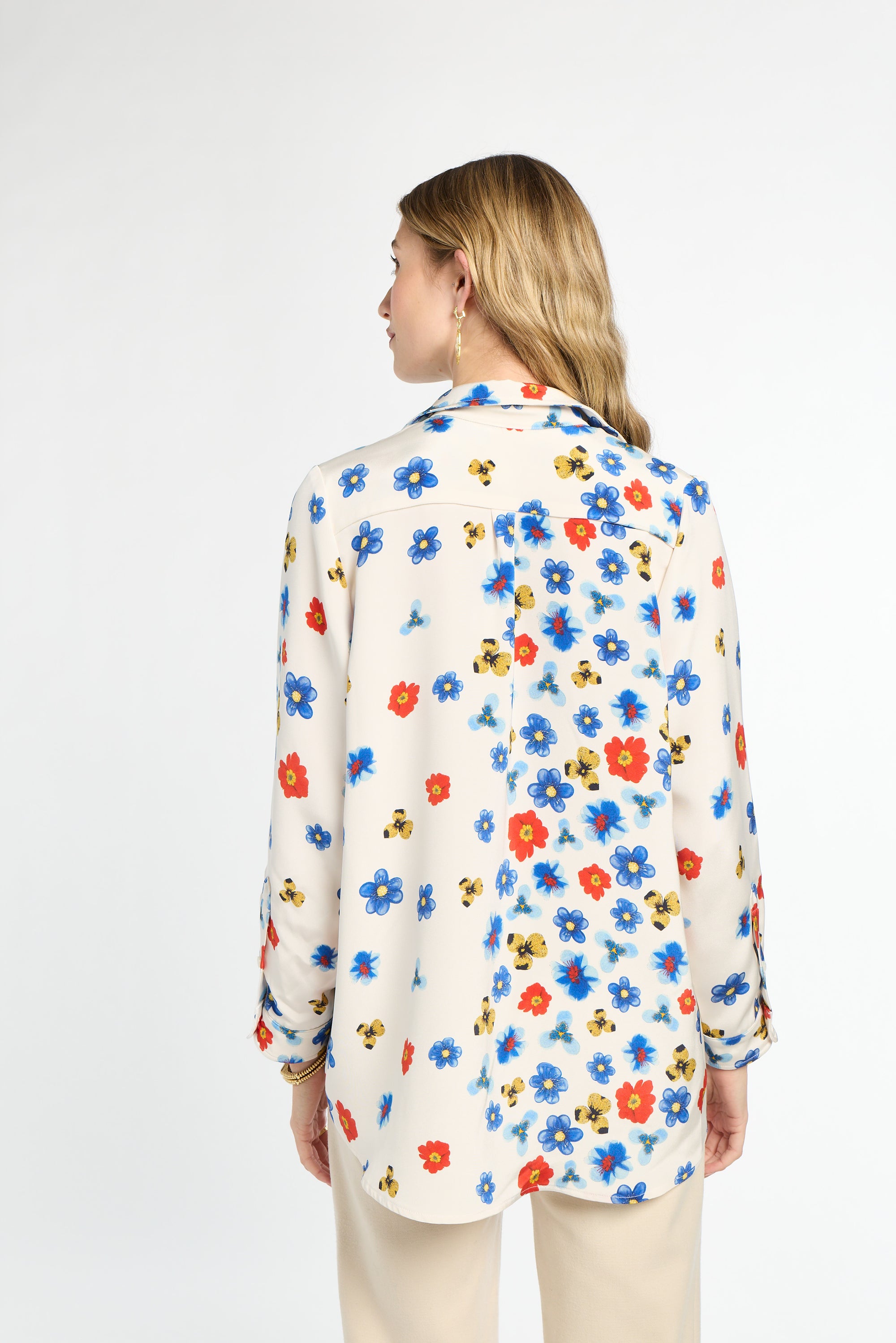 Woman wearing a floral blouse on a white background