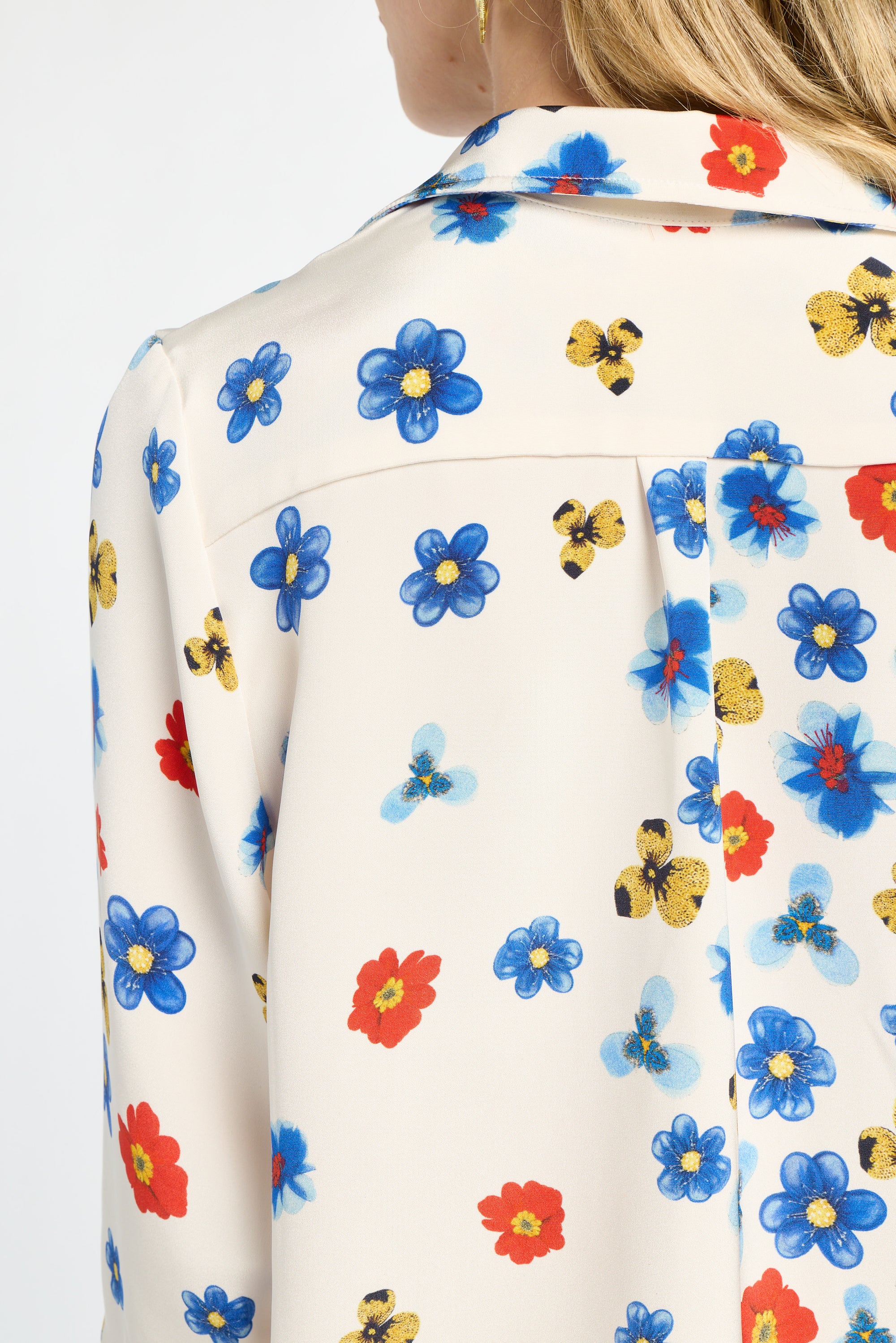 Close-up of a colorful floral patterned shirt with a white background