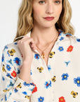 Woman wearing a floral blouse with a white background