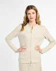 Woman wearing a beige cardigan and skirt set on a white background