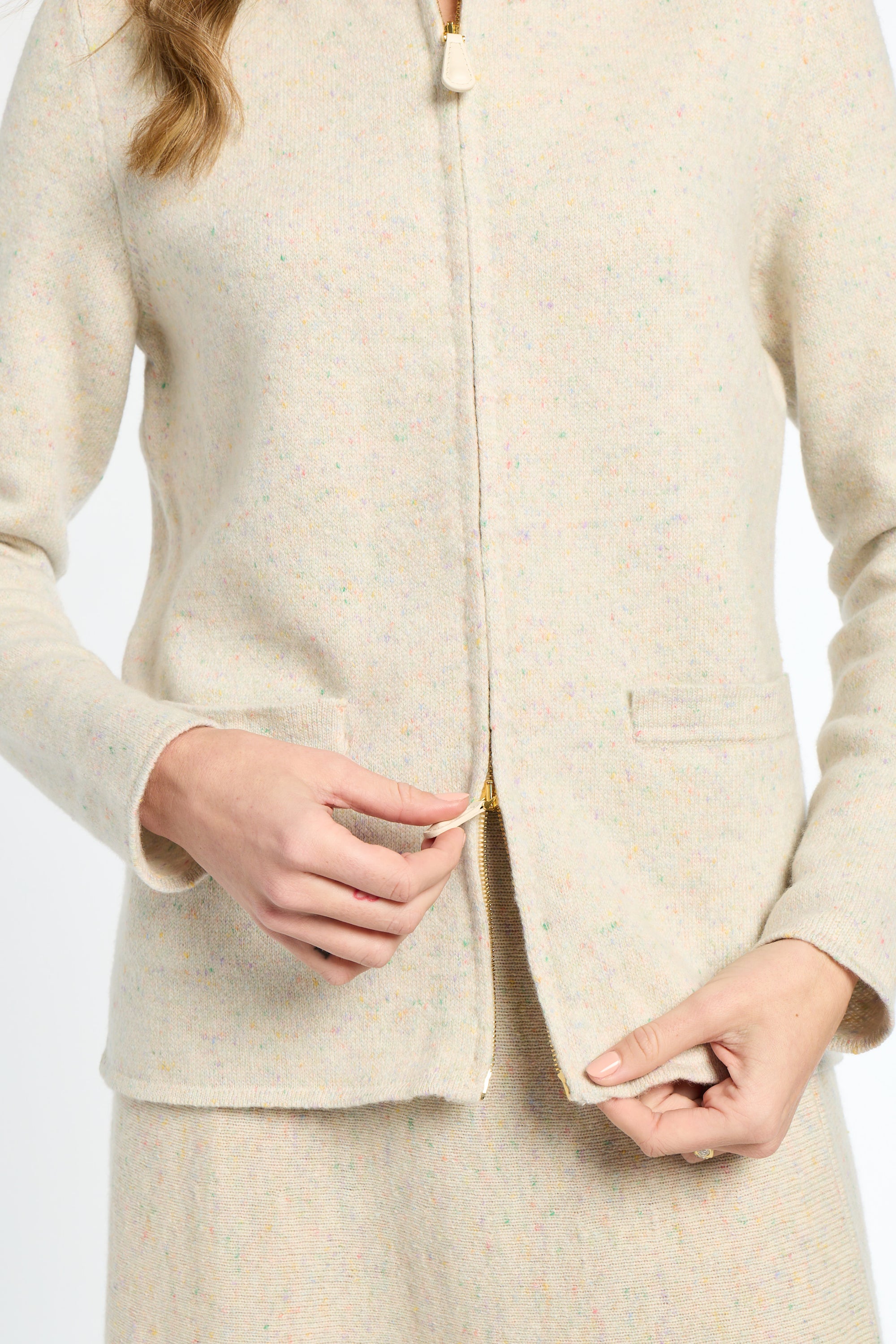 Beige suit jacket worn by a person on a white background