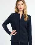 Woman wearing a navy blue zip-up cardigan on a white background