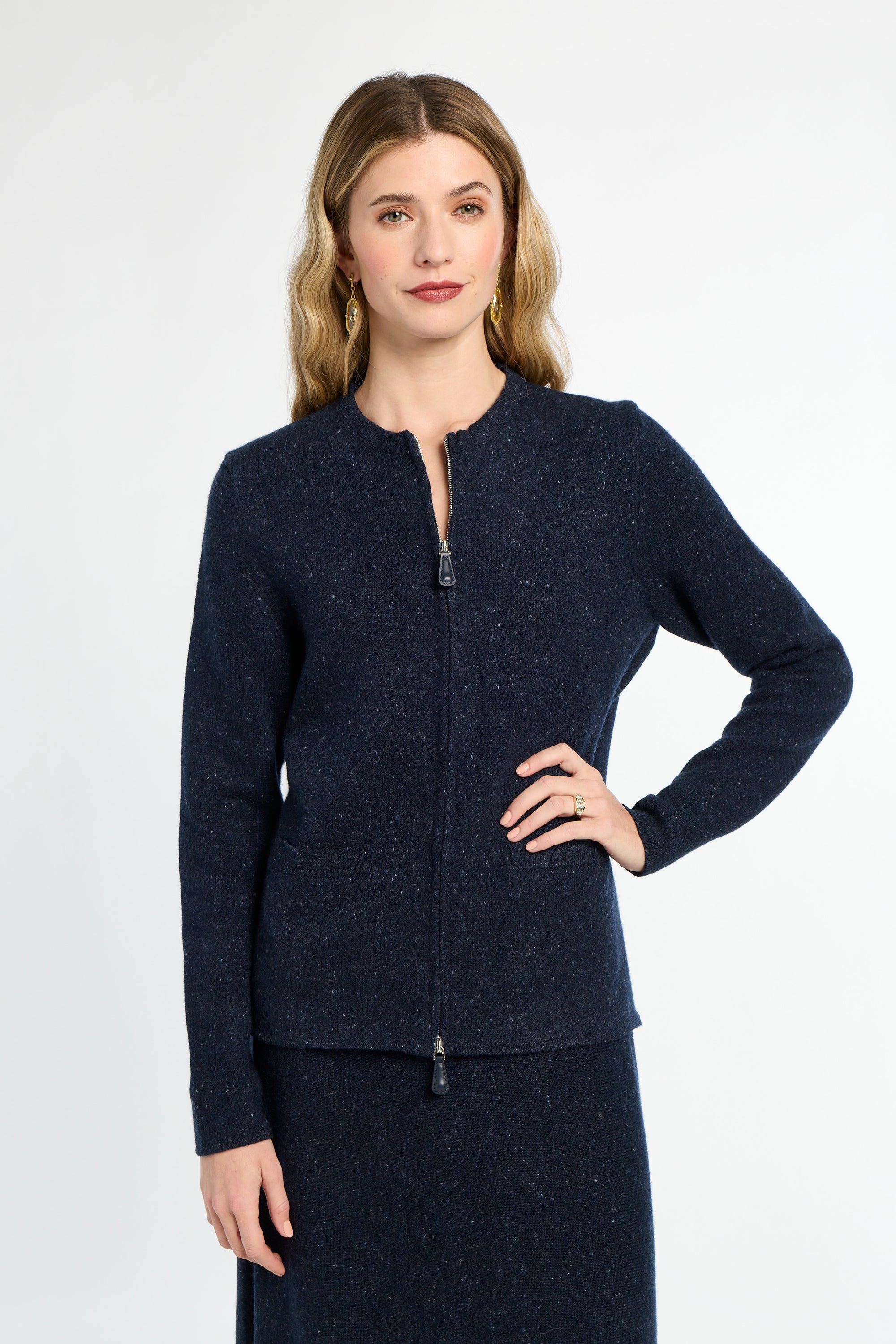Woman wearing a navy blue jacket on a white background