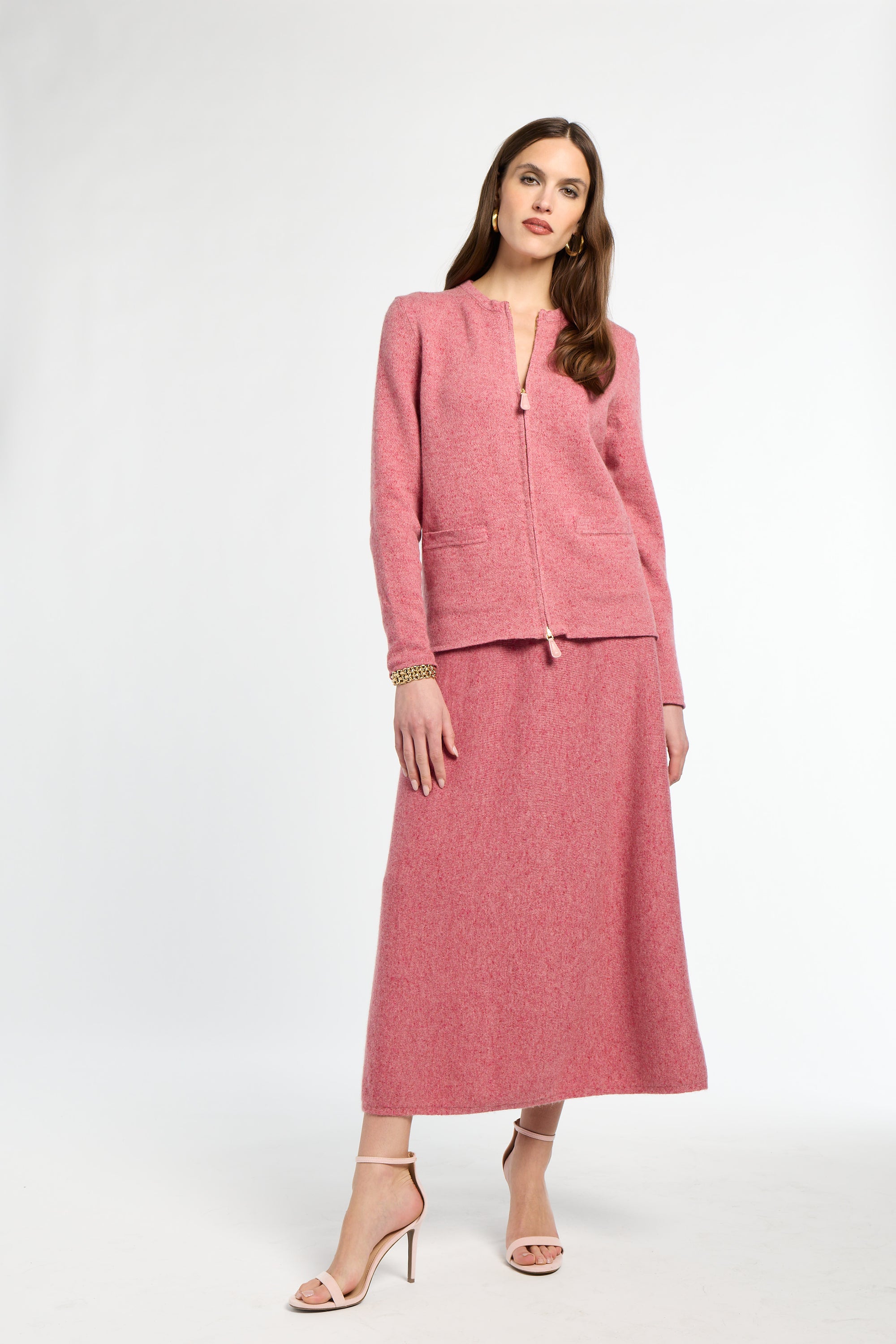 Woman wearing a pink suit on a white background