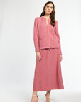 Woman wearing a pink suit on a white background