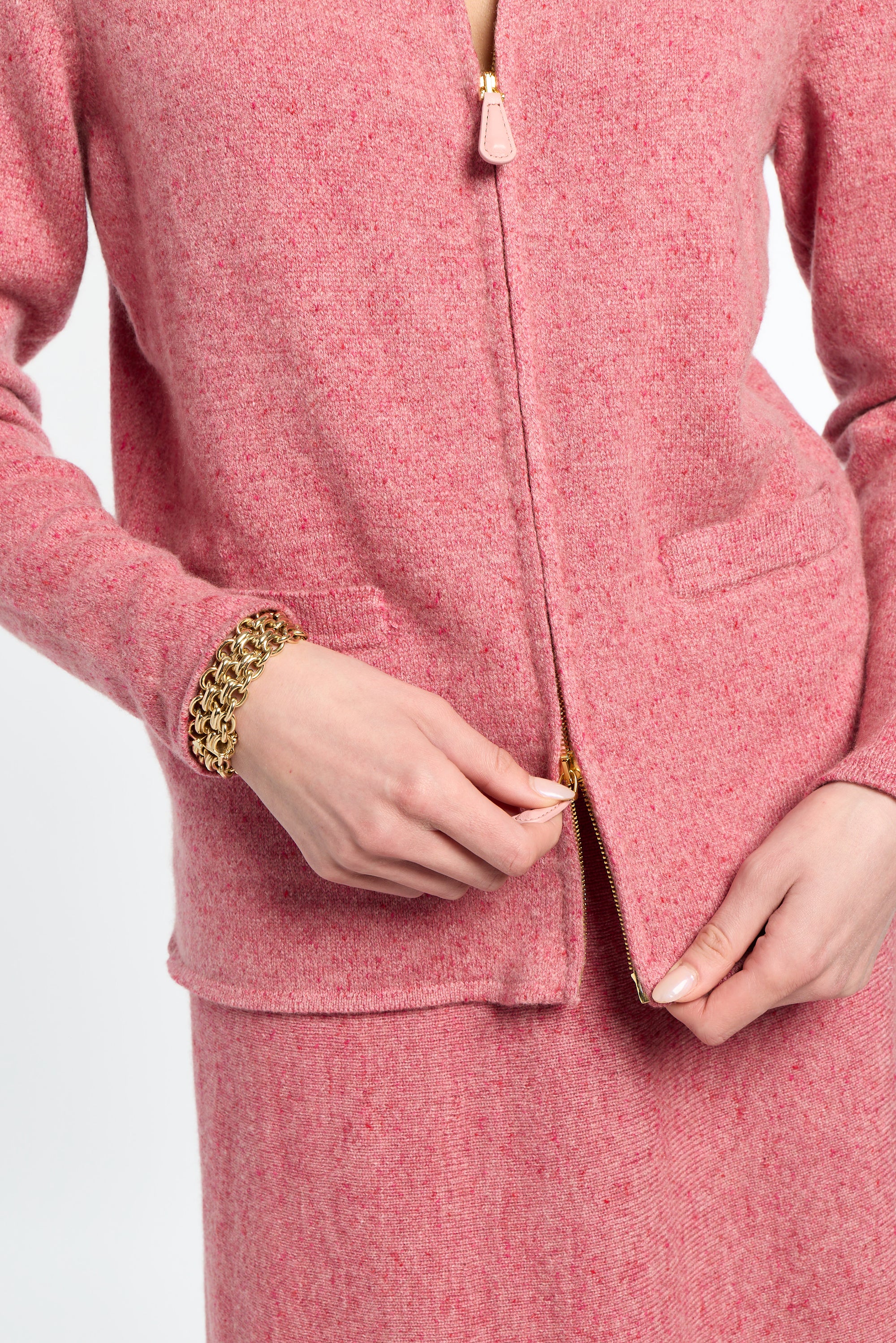 Close-up of a person wearing a pink textured outfit with a white background
