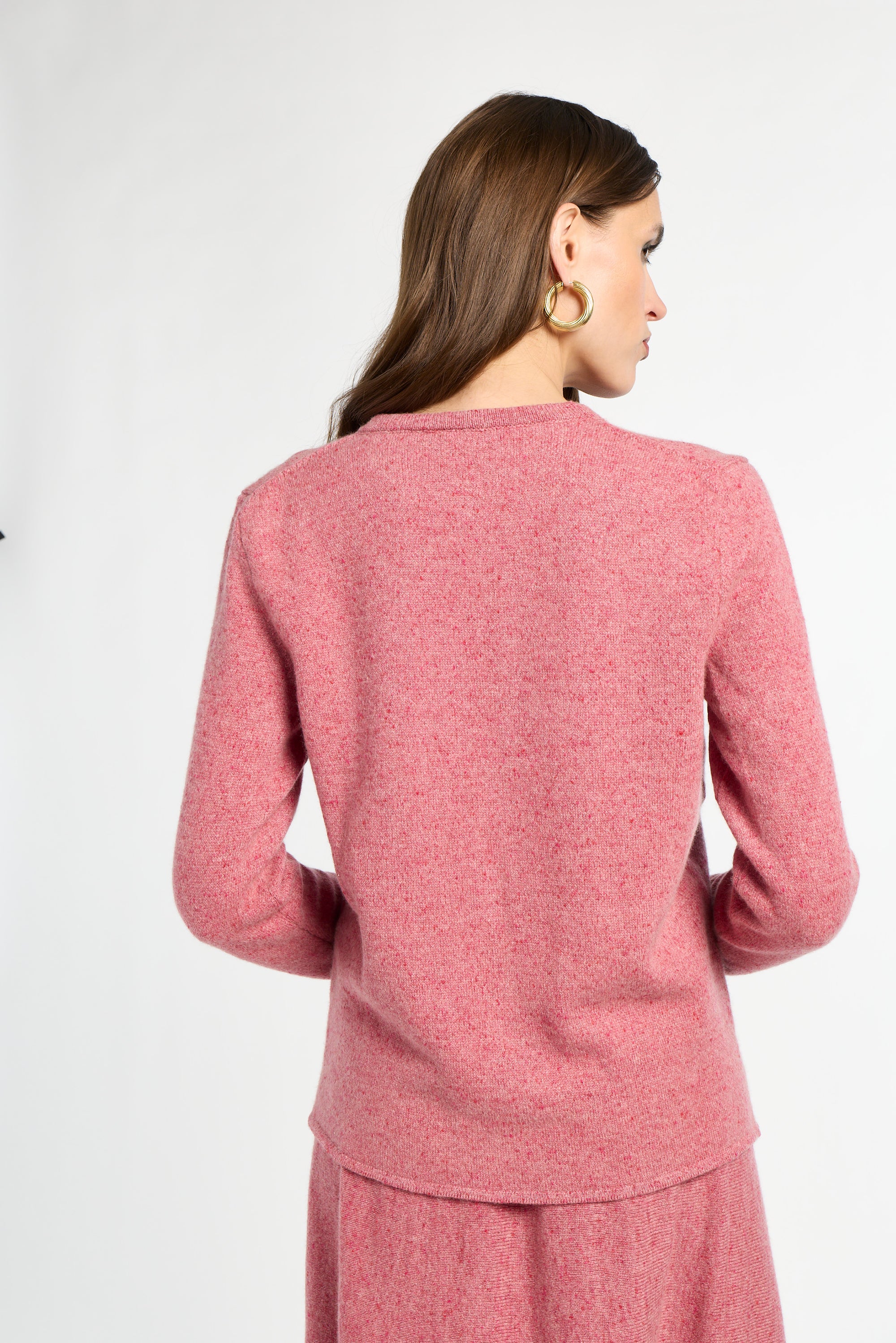 Woman wearing a pink outfit on a white background