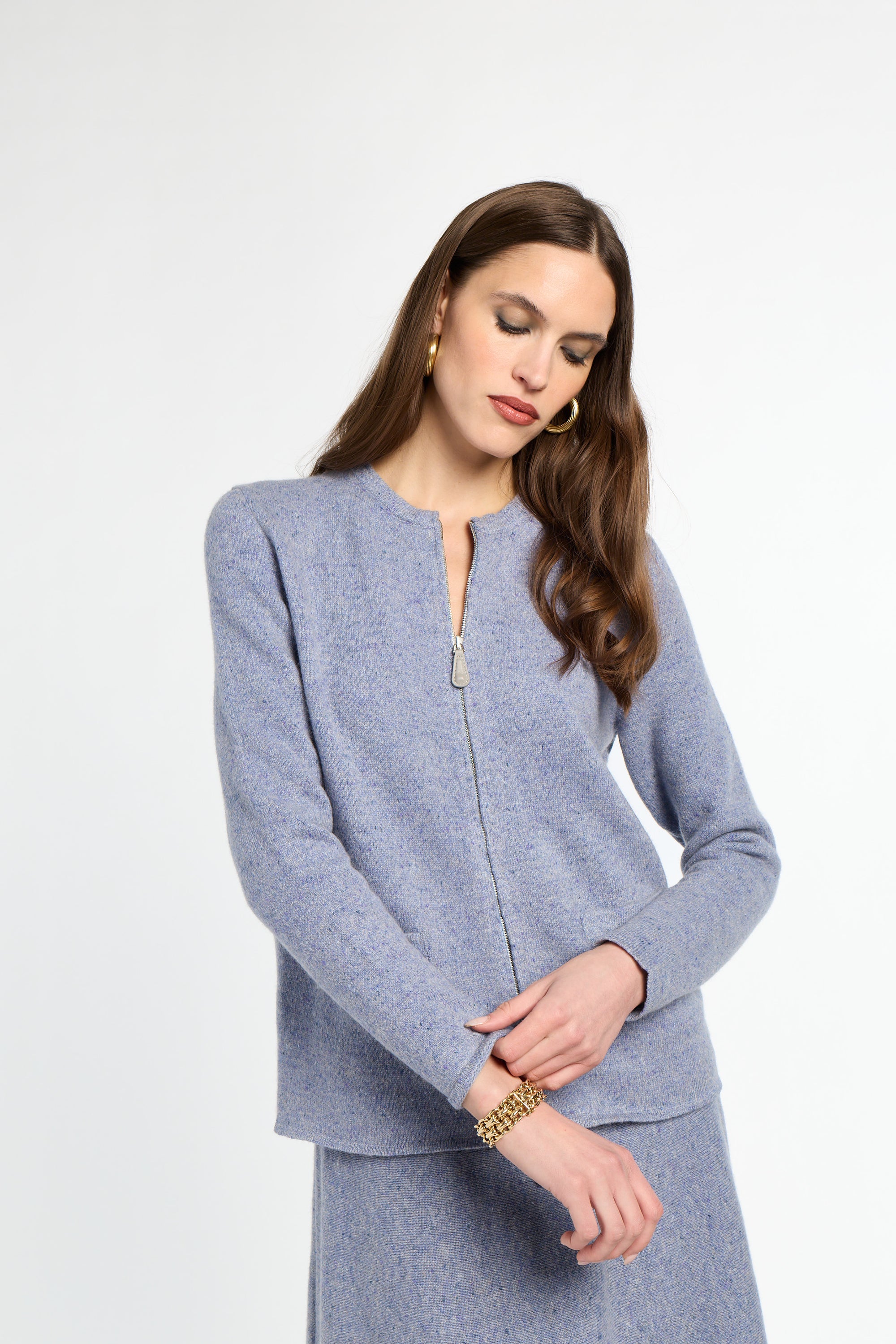 Woman wearing a light blue suit on a white background