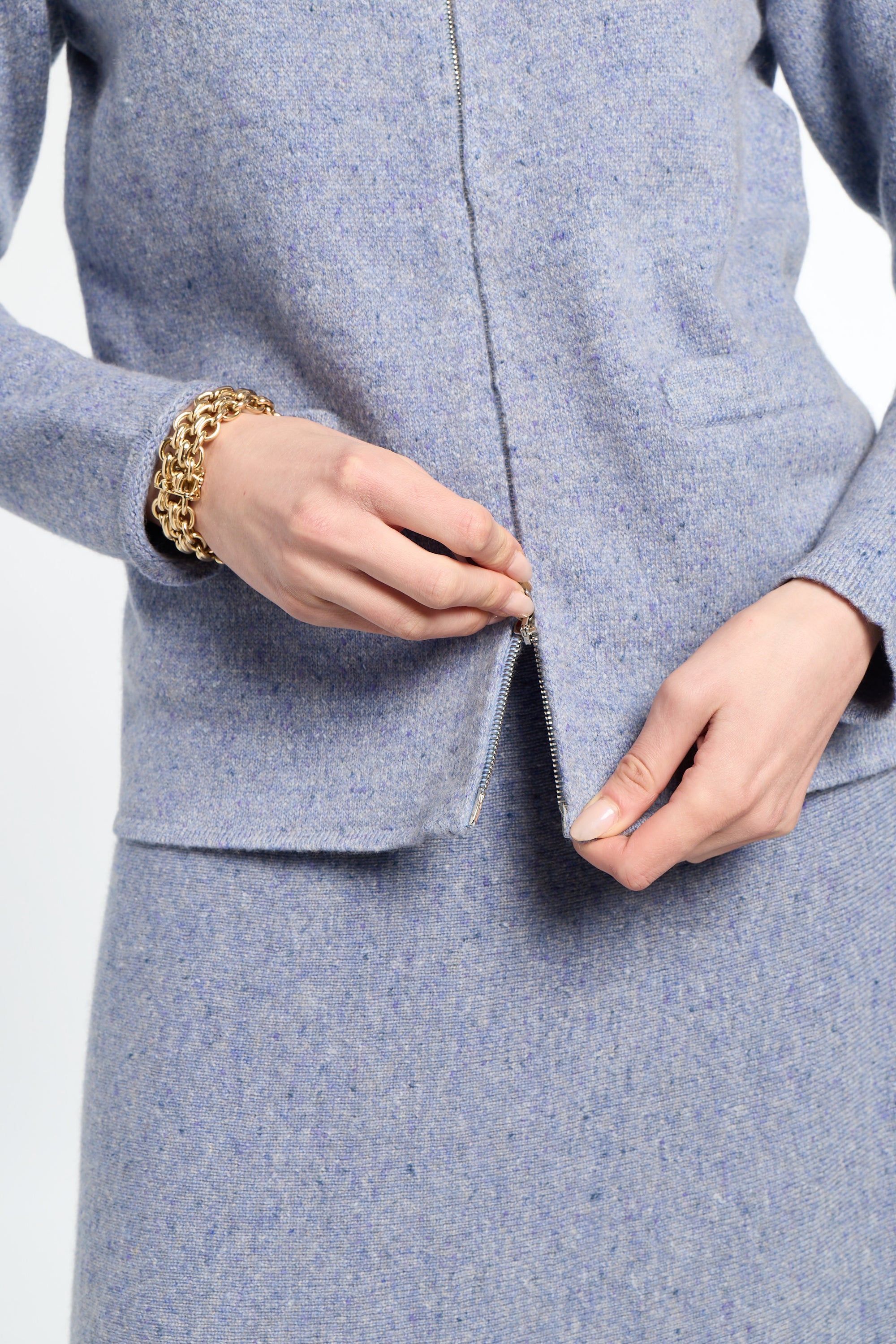 Woman wearing a light blue cardigan on a white background