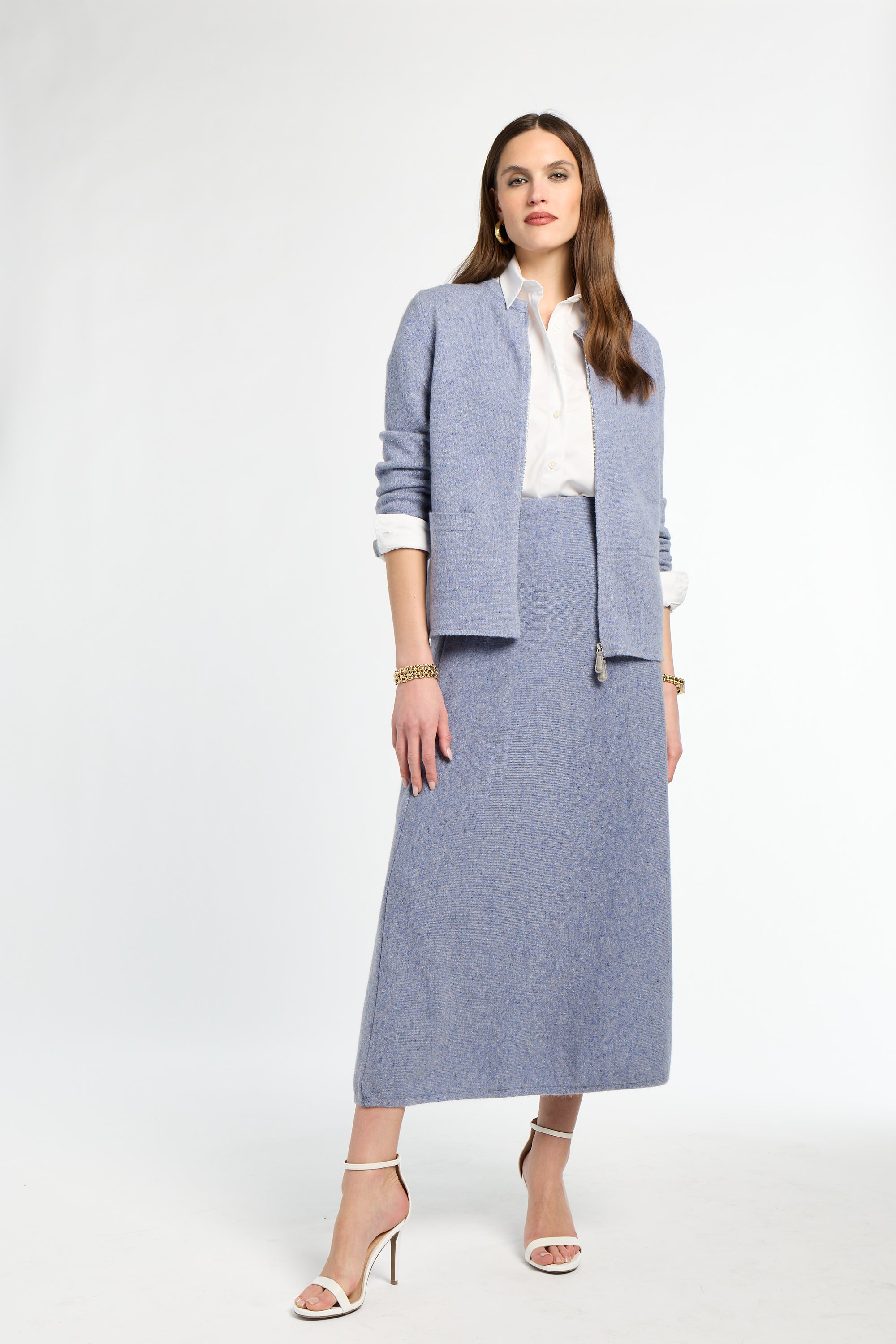 Woman wearing a blue suit with a white shirt on a white background