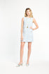 Woman wearing a light blue checkered dress on a white background